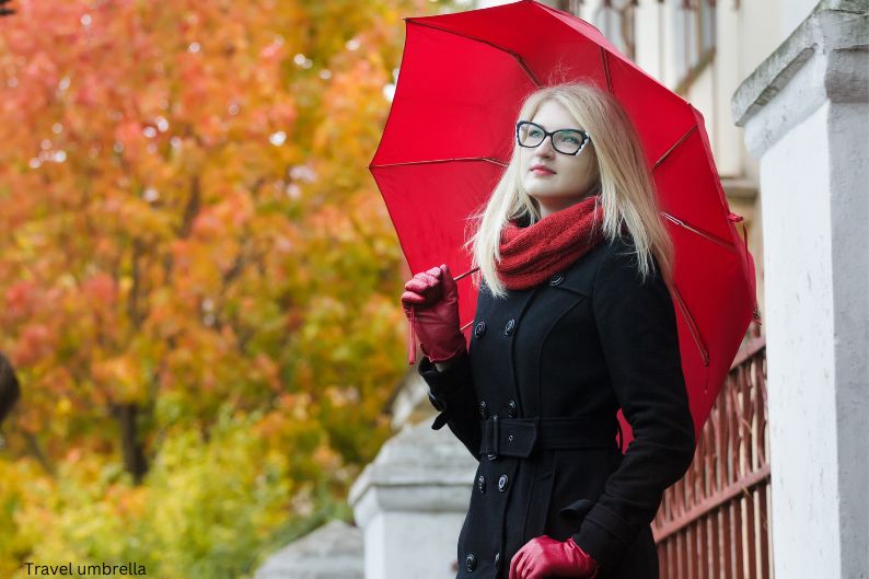 Woman with red travel umbrella